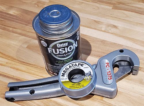 Here are the core tools used on the installation of the central air system. A pipe cutter, pvc cement and thread tape. Not picture cordless drill.